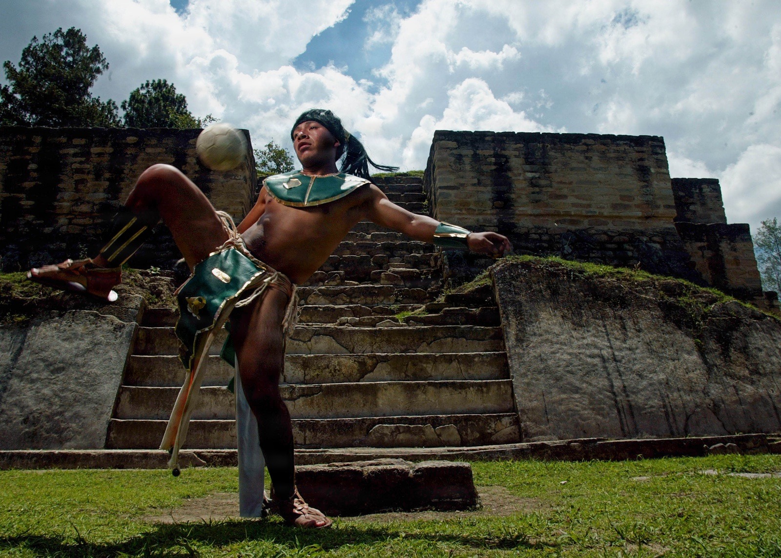 A player uses his knee during an Maya ball exhibition game at Maya ruins May 31, 2005 outside Chimaltenango, Guatemala. The anciant Maya sport, abolished by the Spanish conquerors, was a religious rite for the Mayans, played for 5,000 years on the ball courts found in archeological ruins dotting Mesoamerica. Photo by Daniel LeClair