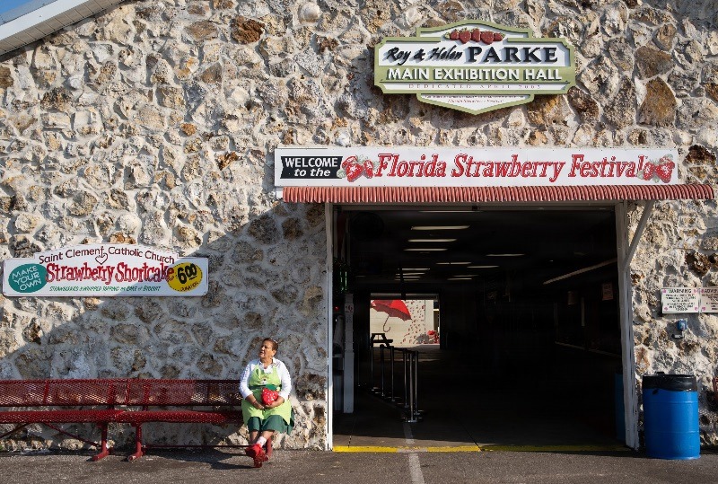 A worker takes a break at the Florida Strawberry Festival in Plant City, Florida March 9, 2025. Photo by Daniel LeClair