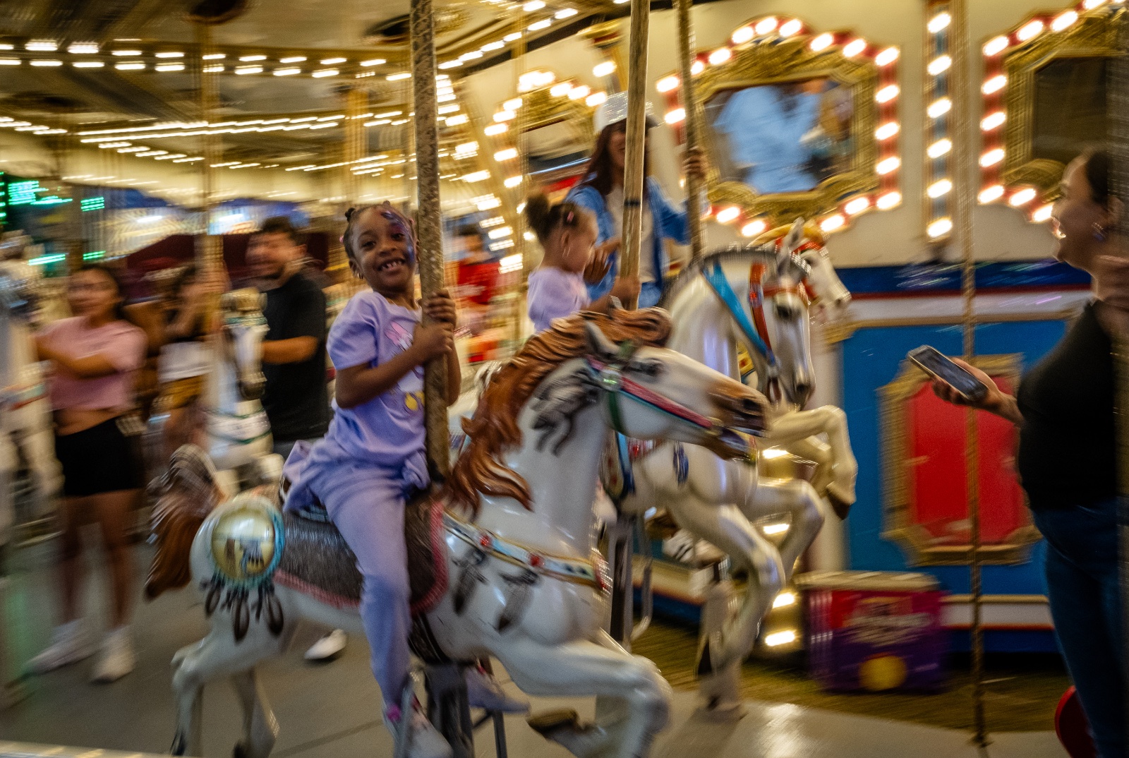 A young girl rides the Carlosel at the Florida Strawberry Festival in Plant City, Florida March 9, 2025. Photo by Daniel LeClair