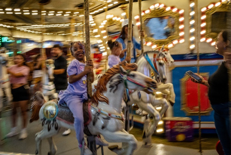 A young girl rides the Carlosel at the Florida Strawberry Festival in Plant City, Florida March 9, 2025. Photo by Daniel LeClair