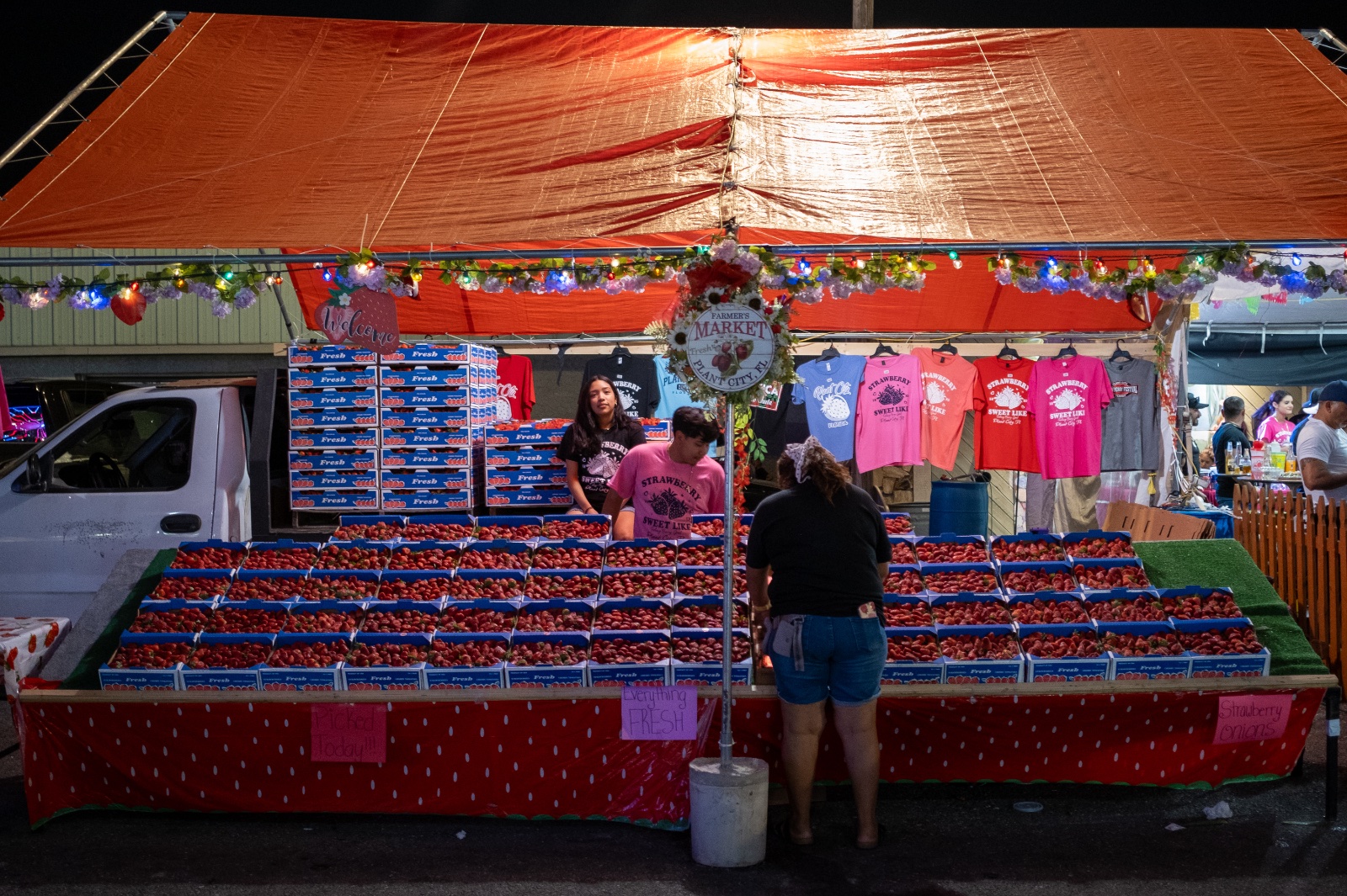 The Molina family tend their stall outside the Florida Strawberry Festival in Plant City, Florida March 9, 2025. Photo by Daniel LeClair