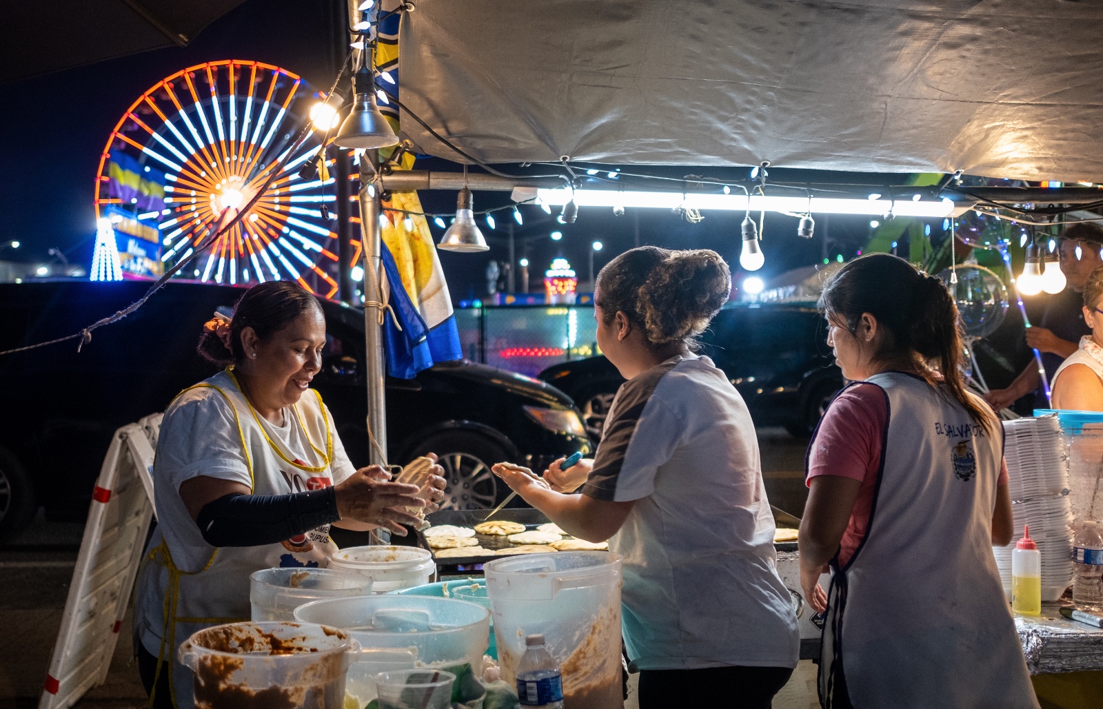 Women make "Pupusas", a traditional Salvadoran stuffed tortilla, outside the Florida Strawberry Festival in Plant City, Florida March 9, 2025. Photo by Daniel LeClair