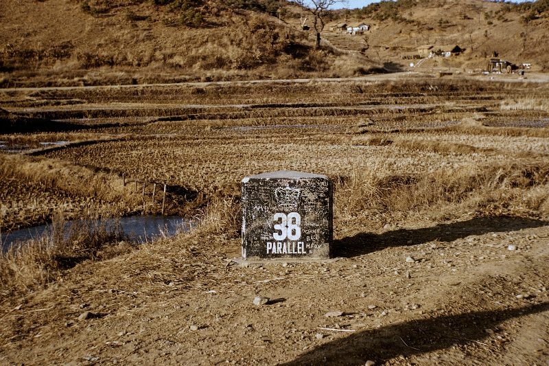 A 38th Parallel marker, bearing a Commonwealth crown, indicates a position where the 38th Parallel cuts a main road, probably in the 1st Commonwealth Division area in Korea. Stone markers were placed at significant points along the 38th Parallel, which were occupied by United Nations forces after the ceasefire.                               