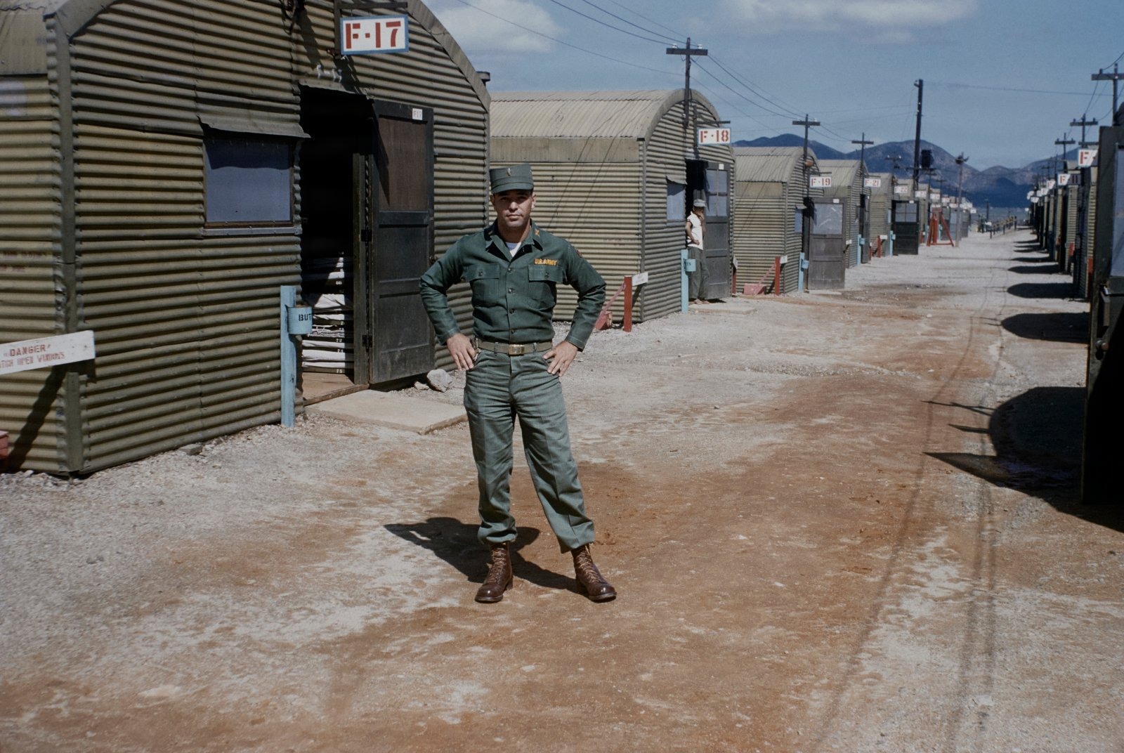 1st Lieutenant Jonathan Hayt stands in front of US Army barracks at a base near Munsan-ni, South Korea in 1955. Original Kodachrome 35mm color slide.