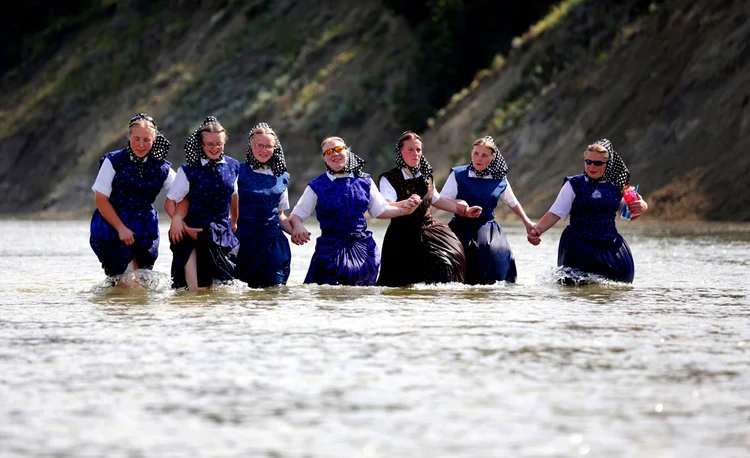 Hutterites cool off in the river
