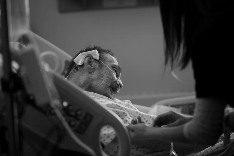 PJ McGrath is his hospital room where he has been for the last 10 months. His back and bony knees propped up as much the bed allowes, his head was frozen in this awkward pose — the end result of cancer and the radiation used to treat it.&amp;nbsp;