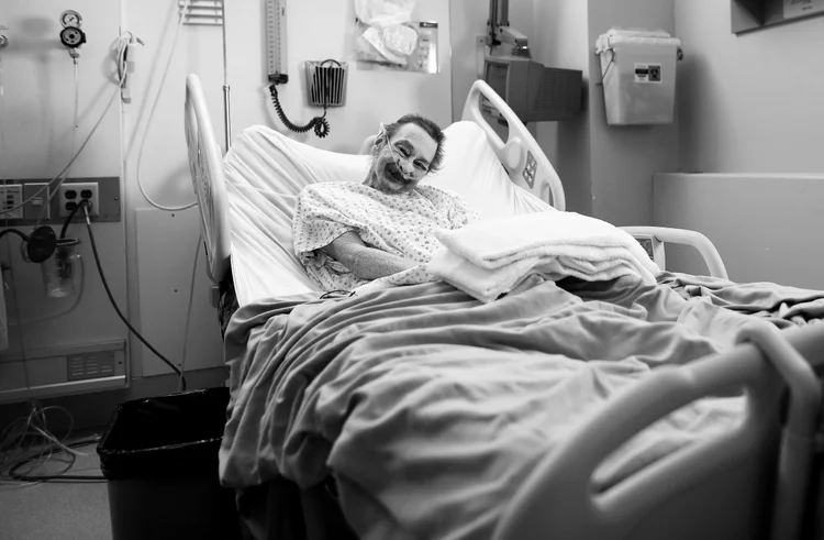 PJ McGrath is his hospital room where he has been for the last 10 months. His back and bony knees propped up as much the bed allowes, his head was frozen in this awkward pose — the end result of cancer and the radiation used to treat it.&amp;nbsp;