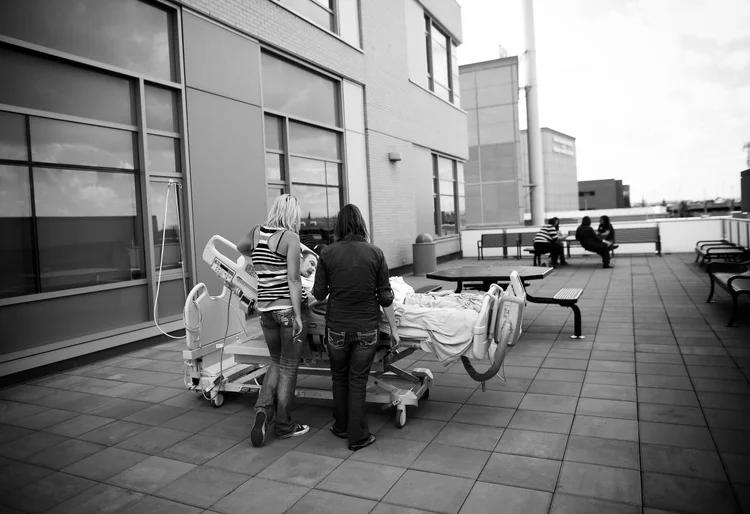 Surrounded by family and friends PJ McGrath enjoys a last smoke on the roof of the hospital where he has been the last ten months.